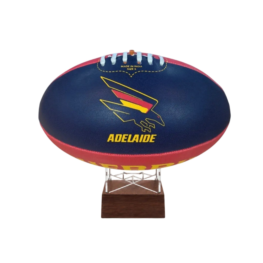 A navy blue Adelaide football ball on a clear acrylic display stand with a dark brown wooden base, featuring the Adelaide Kangaroo logo and &