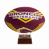 A maroon and gold Brisbane Broncos rugby ball mounted on a clear acrylic display stand with a dark wooden base, shown against a plain white background.