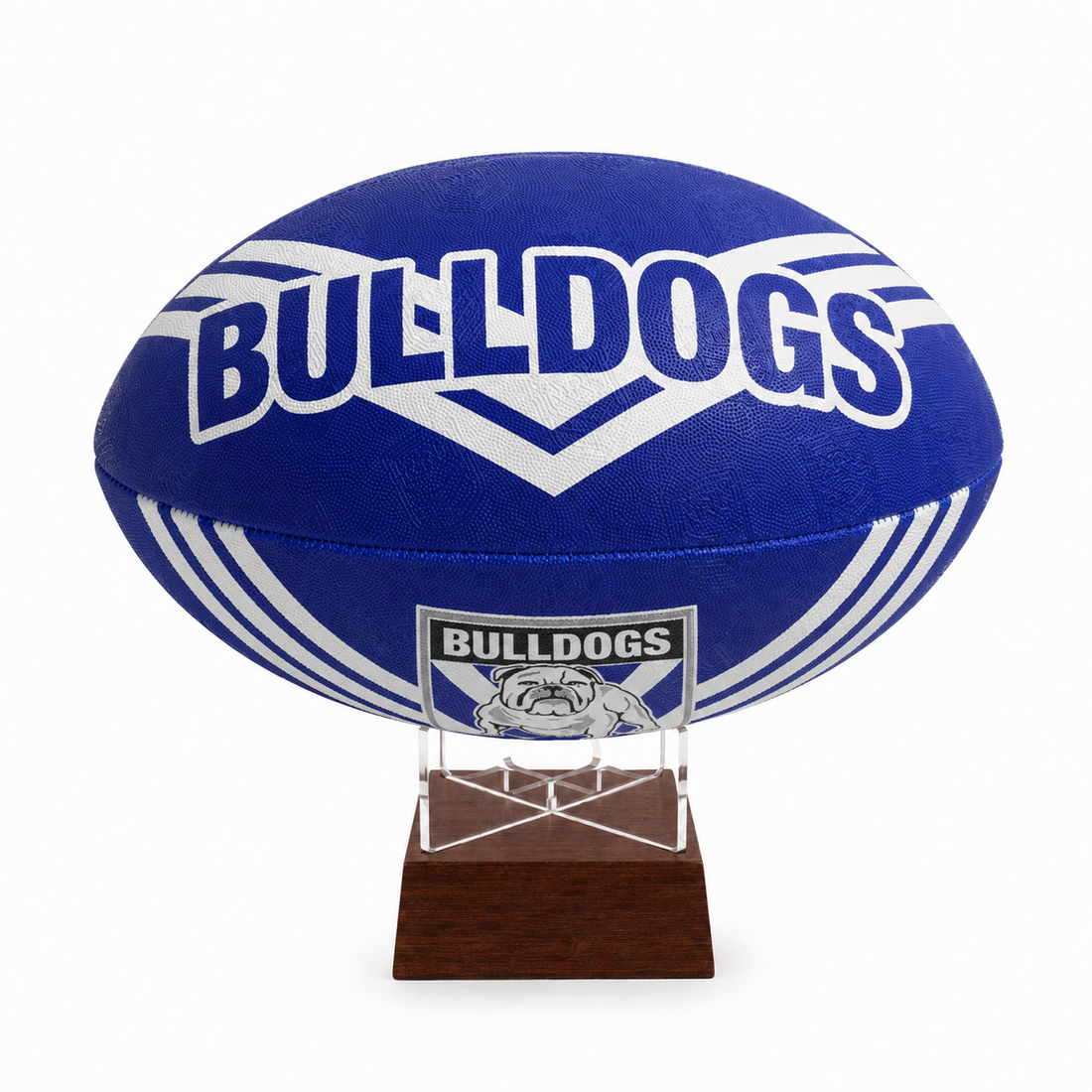 A blue and white Bulldogs rugby ball displayed on a clear acrylic stand with a dark brown wooden base, set against a plain white background.