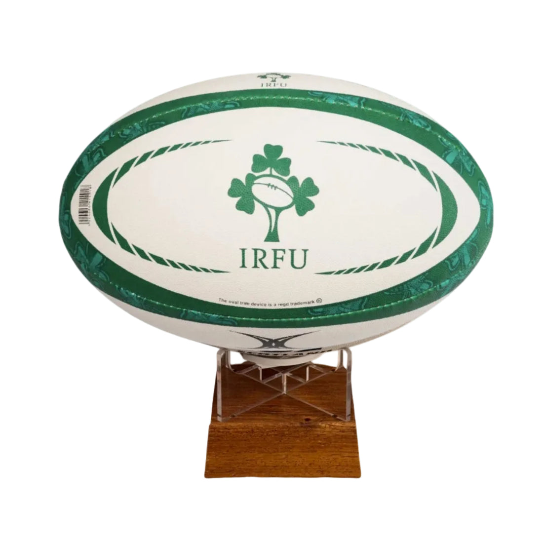 A white rugby ball with green trim and a green shamrock logo with the text &