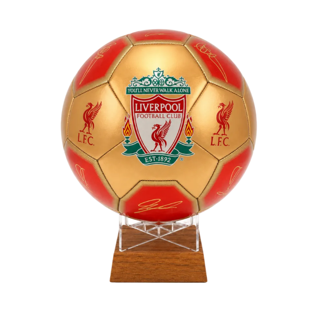 A gold and red soccer ball featuring the Liverpool Football Club crest, displayed on a clear acrylic stand over a wooden base against a white background.