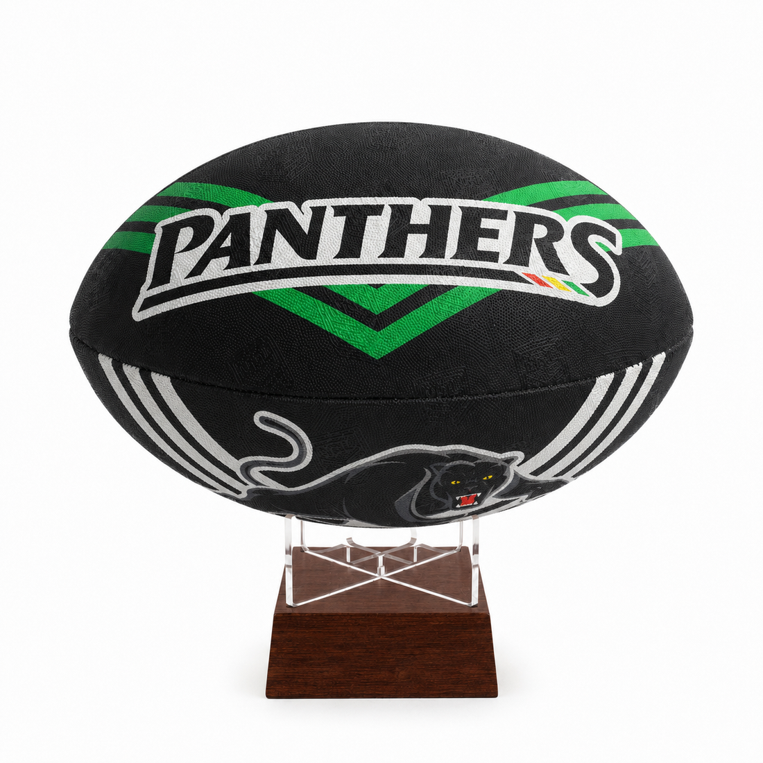 A black rugby ball with green and white &
