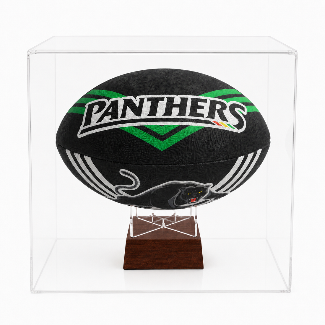 A black Penrith Panthers rugby ball displayed inside a clear acrylic cube case on a dark wood stand, photographed against a clean white background.